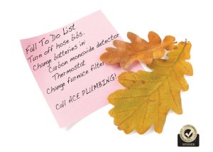 An image of a piece of paper with the fall plumbing checklist written on it. There is also an image of a leaf and a top choice award logo .